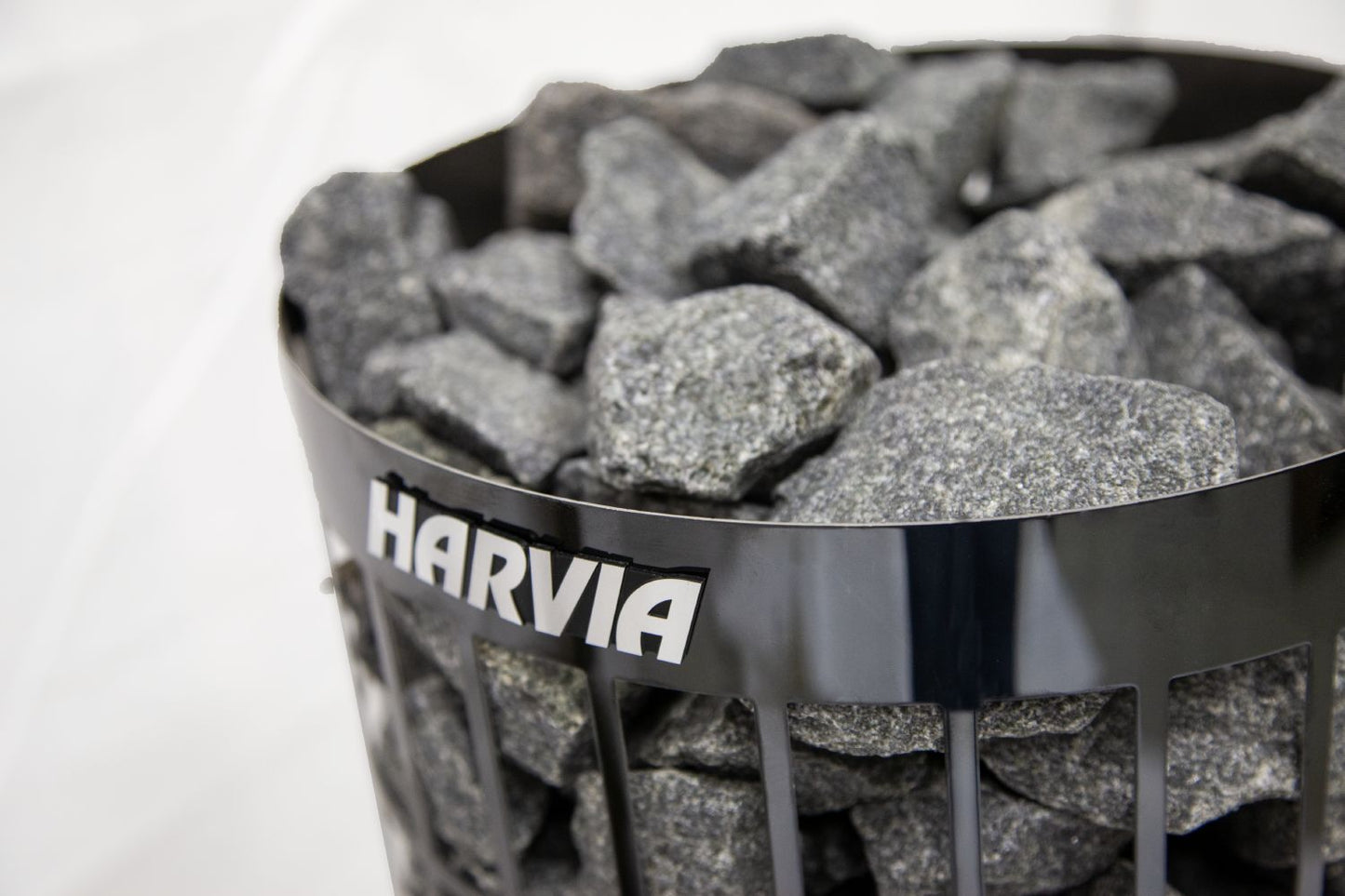 Harvia branded container filled with charcoal briquettes on a white background